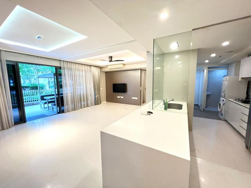 Open-plan living and kitchen at Lakefront Residences, with sliding doors onto the terrace